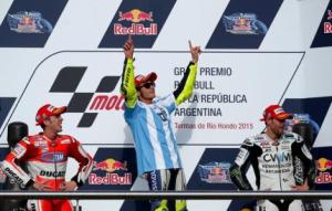 Rossi of Italy celebrates at the podium next to Dovizioso and Crutchlow after he won Argentina's MotoGP Grand Prix in Termas de Rio Hondo